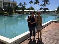 Jordy and Kim standing smiling with the resort swimming pool in the background