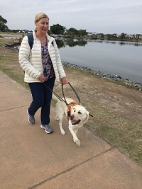 Anne-Marie Walking with dog guide near a lake