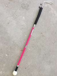 photo of A pink kiddies long cane with raceball tip
