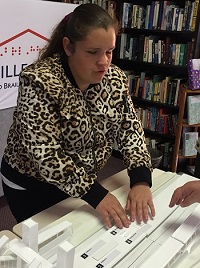 Hailey is seen tactually exploring a 3D map of Fairfield railway station