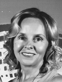  A black and white portrait photo of Kim, O&M Specialist and Director of Forward Steps Mobility