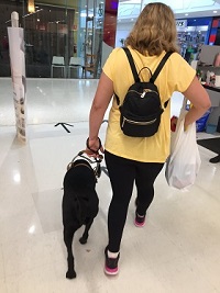 Tarhnee Shopping: Looking behind Tarhnee with dog and shopping bag